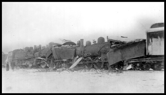 Different view of locomotives from head-on collision of two NP passenger trains, involving 3 Class P-2 locomotives, Nos. 240,241, and 249 at Knowlton, which is today known as Boyle, ND.