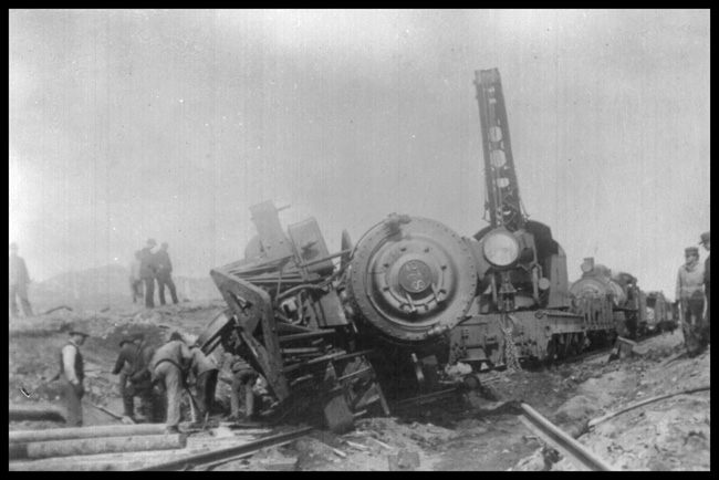 NP 278, Class P turned over on its side at Muir, MT.  Wrecking crew working on picking up locomotive.