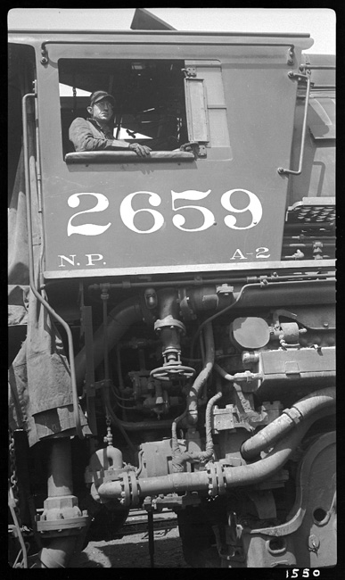 Side view of cab of NP 2659, Class A-2 with hostler in  engineer's seat ready to move locomotive.