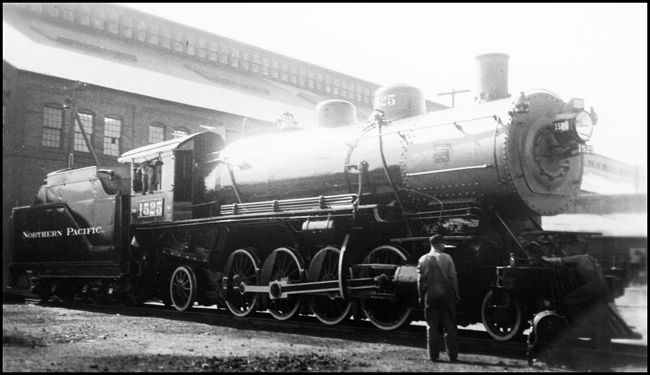 NP 1525, Class W being serviced outside Livingston Backshop by two mechanics.