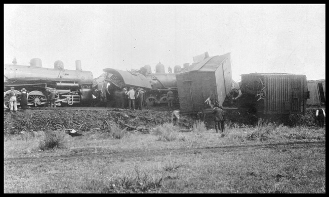 Wreck of No. 4 with NP 2181, Class Q-4 tangling up with Switch engine NP 1111, Class L-9 in Forsyth, MT.  By standers and box cars in view.