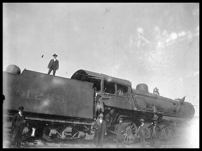 NP 1283, Class Y-4 in an accident at an un-named location.  On-lookers surrounding locomotive may be railroad officials.