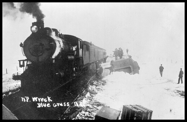 Wreck near Blue Grass, ND with Locomotive NP 2127, Class Q-1.  Blue Grass is in the vicinity of New Salem, ND.  From the appearance in the photo it is possible that the locomotive in view is not NP 2127, but it may be the locomotive pulling the passenger cars shown in photo.  