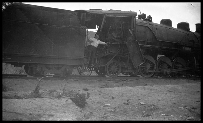 Wreck of NP 2215, Class Q-4, light engine West, with Engr. Adams and work X1562, Class W, at Homestake, MT, May 1930.