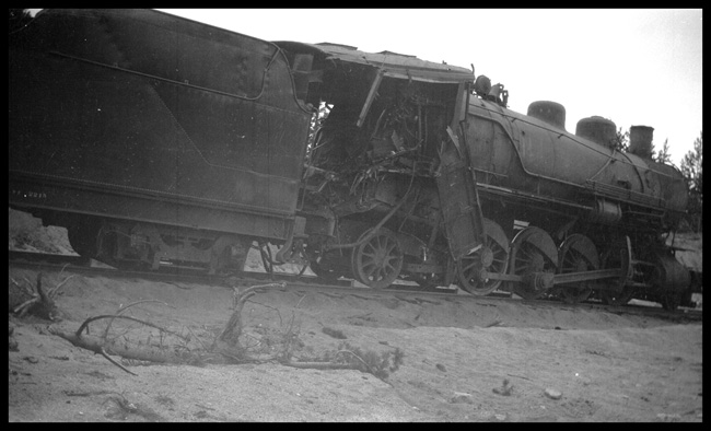 Wreck of NP 2215, Class Q-4, light engine West, with Engr. Adams and work X1562, Class W, at Homestake, MT, May 1930.