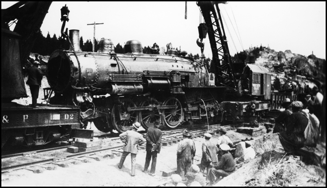 Picking up wreck of NP 2215, Class Q-4, light engine West, with Engr. Adams and work X1562, Class W, at Homestake, MT, May 1930. Two wreckers working the accident, BAP D-2 out of Butte and NP 41 out of Livingston.