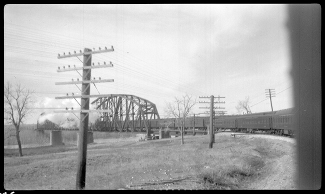NP Train No. 3 pulled by NP 2233, Class Q-5 crossing Missouri river at Bismarck, ND.  Missouri River Bridge visible.
