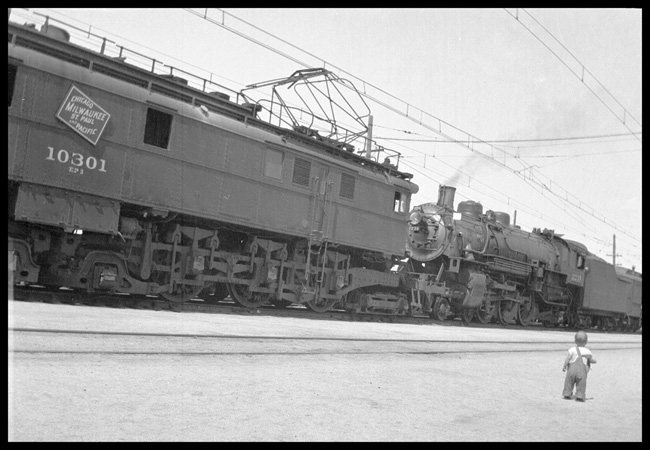 NP 2234, Class Q-5 with Train No. 1 following behind CMStP&P 10301 Electric locomotive as No. 1 detours over Milwaukee tracks.