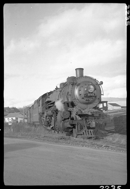NP 1781, Class W-3  on Train No. 844 at Polson, MT.  Considering this photo was taken in Decemberember, it appears crew may have secured their Christmas trees during this trip to Polson, as it looks like two Christmas trees are tied to the front of the locomotive..