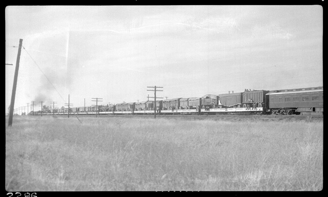 NP 1835, Class W-5, as X1835W pulling circus train out of Missoula, MT.  Not sure if train is moving, but there appears to be all kinds of people riding on the open flat cars loaded with the trailers.
