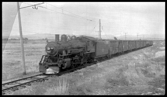 MILW 1008, 4-6-0, with Westbound freight train on Gallatin Valley branch arriving Three Forks, MT.  This photo shows the beginning of the catinary for electric operation on this line.