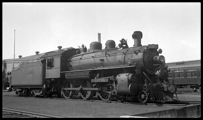 Smokestack covered and settled in for a long summer nap, ten-wheeler 1365 rests at the edge of a turntable pit. This engine was built by Montreal for the Canadian Northern in 1912.  It would see another 24 years of service.