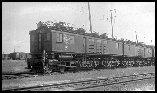 The pantagraphs are down and the track is not high iron, so the woman on the footboard wkill probably not be going anywhere on this big Milwaukee electric.