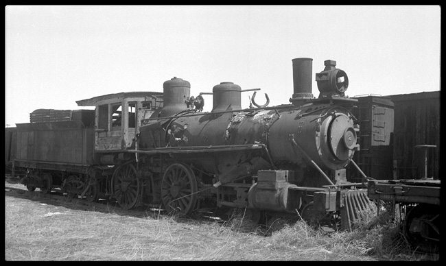 A well-weathered 4-4-0, formerly of the Union Pacific, has another day in A Denver junkyard, years after the closing of the Denver Laramie & NorthWestern