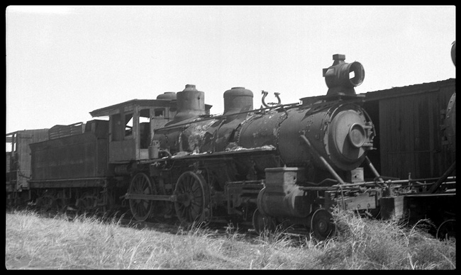 The bell is missing and all of the glass is gone, but mosty of the hulk remains amidst other broken and discarded equipment.  This was once a Union Pacific engine