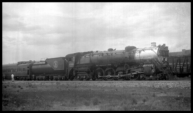 GN 2588  Whitefish, MT. GN class S-2  4-8-4  Baldwin 1930 Right side view of psgr train  Smokebox is a very bright silver/white  Onlooker unknown