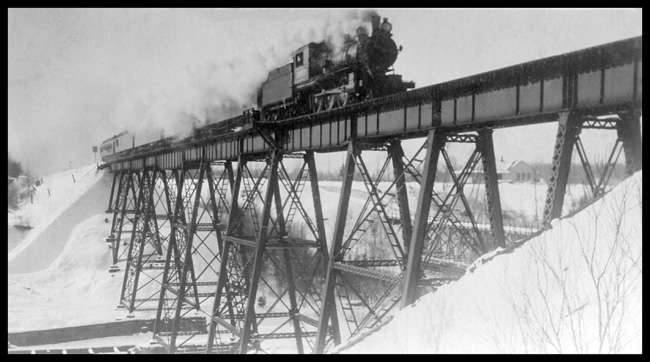 GN Psgr Eng 1057 on trestle near Dedham, Minn. GN class E-14  4-6-0  Baldwin  1909 train on steel trestle  Cars obscured by smoke.