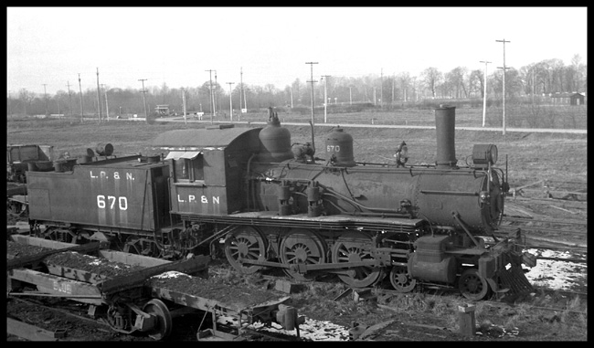 Longview, Portland and Northern No. 670, 4-6-0 beside some log flat cars at Longview, Washington. She was formerly Colorado Midland No. 14.