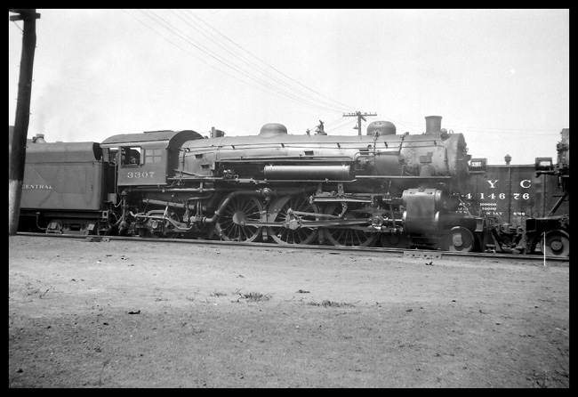 NYC 3307  Buffalo NY  5/28 Left side view of New York Central 4-6-2 in line with another, cropped loco  Smoke in bkgrnd