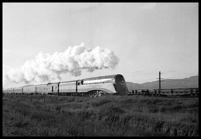 NYC X2847W arriving Whitehall  6/36 RF 3/4 view of Rexall Streamliner demonstration train at speed.  Last few cars cropped  Fence line Mountains in background  See RVN03673-4,6