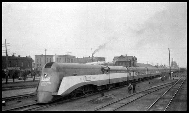 NYC 2847 disguised as the Rexall Streamliner running as an eastbound passenger extra on a tour to promote the drugstore chain, arriving Missoula, Montana on Jun. 4, 1936. Note the second story of the old Missoula depot behind the train.