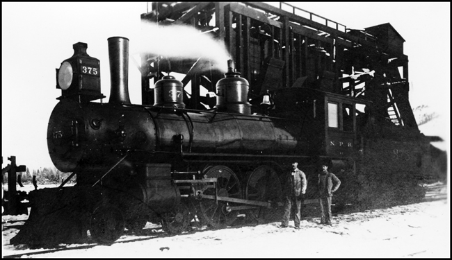 NP 375, Class E-2 locomotive at coal dock in Missoula, Mt with two crew men doing service to the engine.