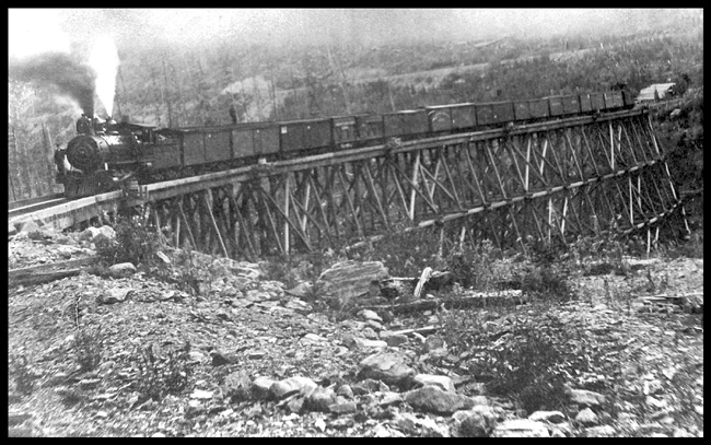 NP 79 with train on S bridge  Wallace branch about 1912  cy  JR Smith A posed left side view of class F-1  2-8-0 [Baldwin 1888] on 12 car freight train on high wood trestle  The photo does not really show how the trestle forms an 