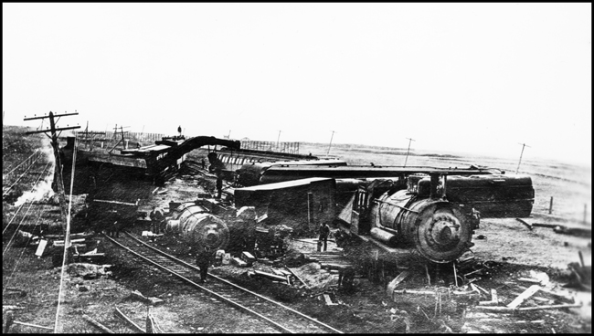 Wreck remains of accident involving NP 2351, Class T locomotive and another locomotive which must have been in passenger service. Appears this may have been a side swipe collision between Bloom and Jamestown, ND.