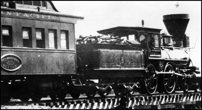 NP 8, 4-4-0 locomotive with balloon stack pulls a business type car across a bridge.  Office Car is marked with a plate indicating RY Masters Office.