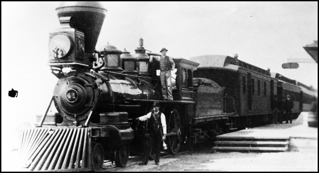 NP 41, 4-4-0 locomotive being service during station stop with Passenger train at an unknown location  and on an unknown date.
