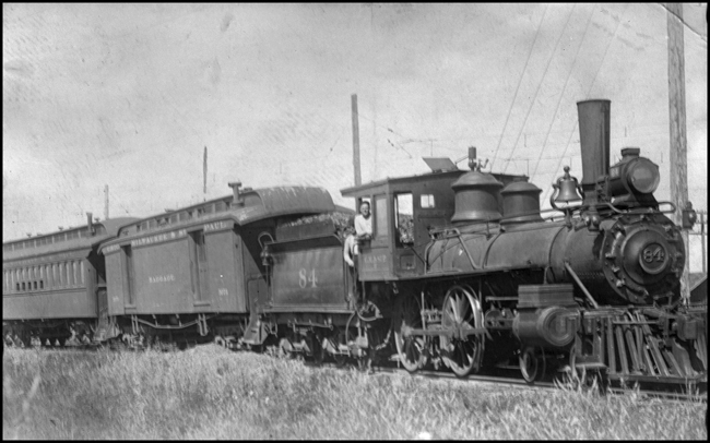 CM&SP 84 dupe  The information here is based on RVN06454, an image not in the collection  It is a copy negative of a photo by Frank Black that Nixon acquired from Warren McGee  The passenger train is on the GV [Gallatin Valley?]  MILW's catenary is visible in the background