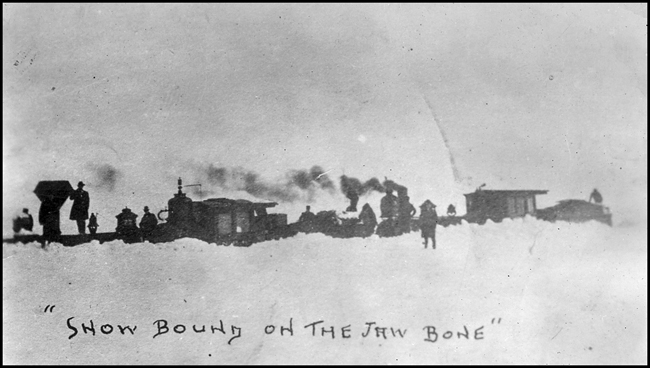 NP 774 and Montana 5 stuck in snow drift near Judith Gap on Montana RR  1903  Copy negative from LeFever  The Montana RR was initially under NP control, leaving the NP at Lombard and making its way up 16 mile creek canyon  It eventually became part of the MILW  main line  It was nicknamed 