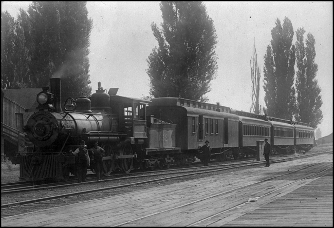 NP 652, 4-4-0 locomotive with passenger train No. 12, in Lewiston, ID.  Crew members on platform in picture.