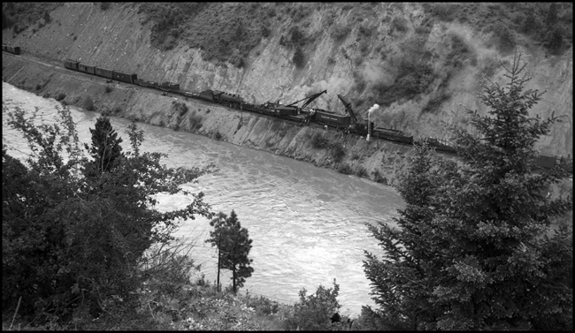 Two wreckers preparing to rerail NP 5140 which turned over due to derailment of X5140W when it encountered a broken 130 lb. rail near St. Regis, MT.  Photo taken from north hill.