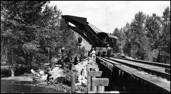 NP wreckers NP 41 and NP 44 lifting NP 1356, Class S-4 out of the river after a derailment at bridge 23.2 because of a washout.