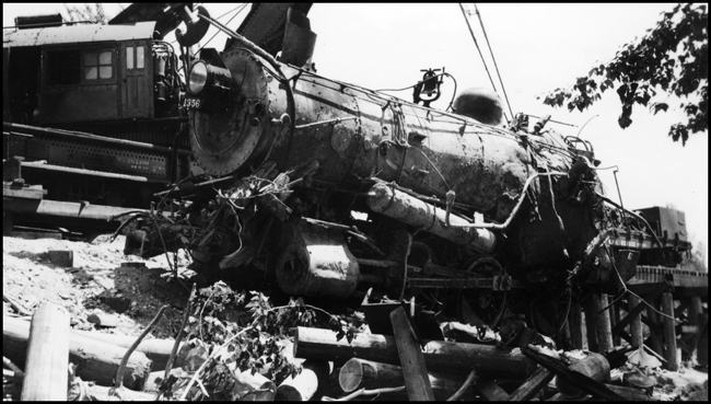 View of the front end of NP 1356, in the slings of Wreckers 41 and 44 as they bring the locomotive out of the Bitter Root River, after the washout derailment on Bridge 23.2.