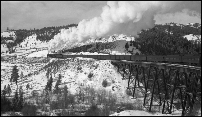 NP 2nd No. 3 with NP 2606, Class A locomotive crosses trestle near Weed, MT.