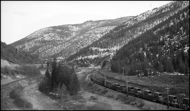 MILW  XE35E near Saltese, MT, loaded with several cars full of military equipment.