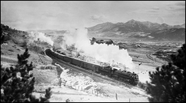 NP Psgr train No. 1 pulled by NP 2650, Class A-3 and helped by NP 2652, Class W-3 locomotives climbing Bozeman Hill west of Livingston, MT 
