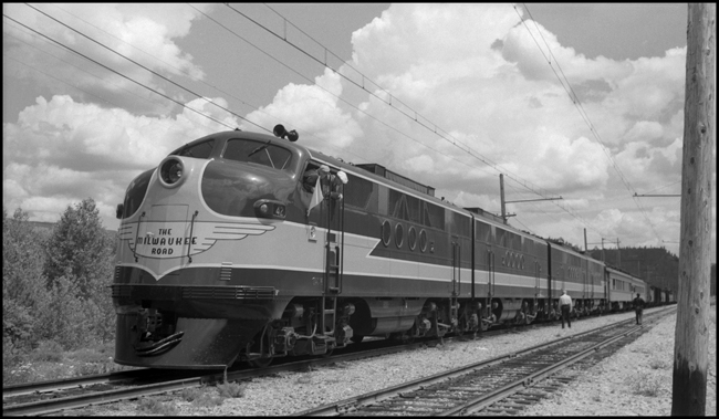 MILW 42 Diesel Electric locomotive, on test train with crew members on the ground. The two passenger cars on the head end were obviously for the test crew.