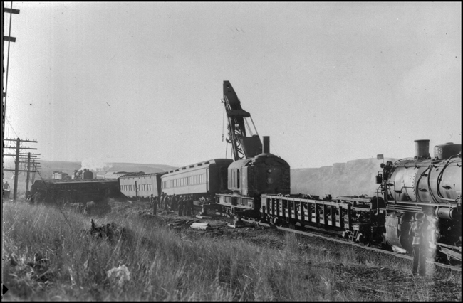 NP 5132 wreck near Logan, with wrecker in process of lifting a derailed coach.