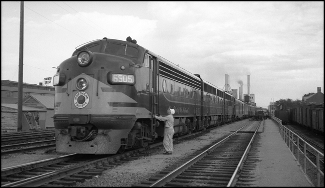 NP train 1, NCL, with F-3 diesel 6505, stands at Fargo, with crewman by engine.