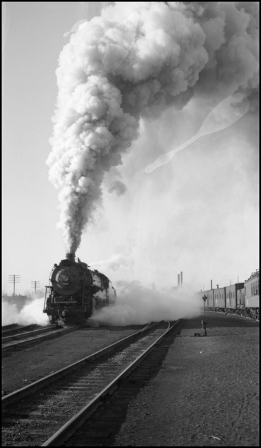 In a big plume of smoke, NP 4-8-4 no. 2663 leaves Missoula on second no. 2, NCL. Outfit cars on right.