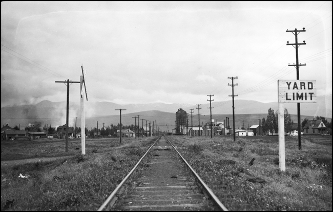 NP yard tracks, grade crossing, coal dock (distant), Fifth Street, Missoula.