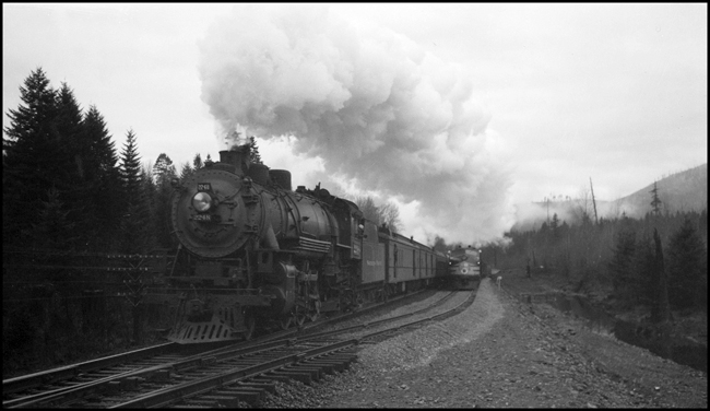 NP train 4, eastbound Alaskan, with 4-6-2 engine 2248, passes X6003E with new FT diesel, Maywood, WA.