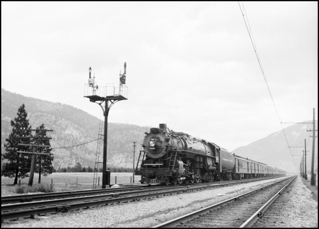 NP Class A3, 2665 hauls the first section of the NCL, Train No. 1 by the double semaphore signal bridge near Bonner MT.