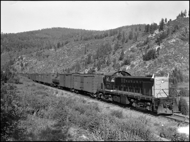Extra 155 West, east of Evaro, MT. The Alco RS-1 was renumbered 800 in 1950. This train will operate as No. 843, Dixon to Polson.