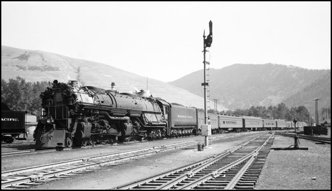 First No. 1, the westbound North Coast Limited, arrives Missoula, MT behind engine 5121, a class Z-7 4-6-6-4. Some of the cars in the train carry troops.