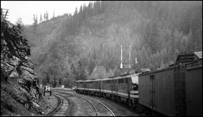 NP Extra 6001 West, powered by a four-unit FT diesel, is about to enter Stampede Tunnel #3, out of view around the curve, at Martin, Washington.