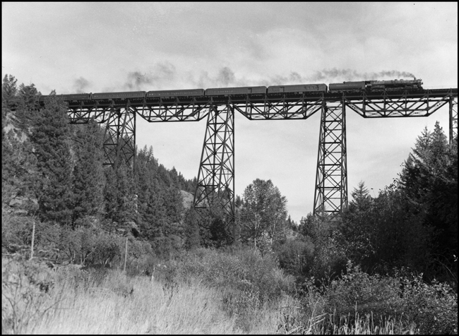 NP First No. 2, powered by Class A-3 4-8-4 no. 2665, Engineer L. H. Taylor, crosses Marent Trestle, just west of Nagos, Montana.